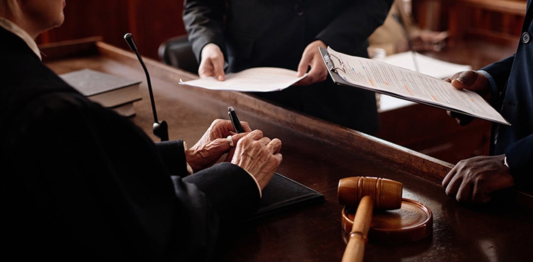 Attorneys reviewing documents in a courtroom