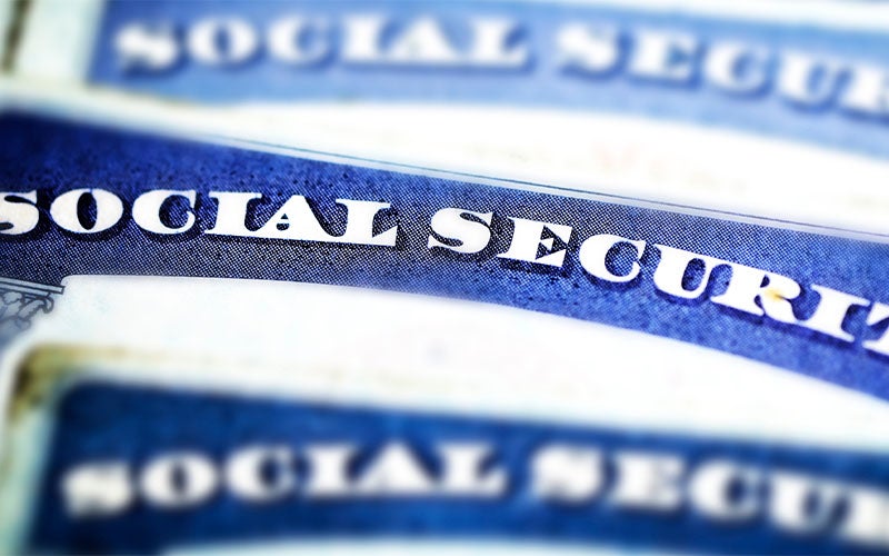 Close-up of a Social Security card showing the words 'SOCIAL SECURITY' in blue text.